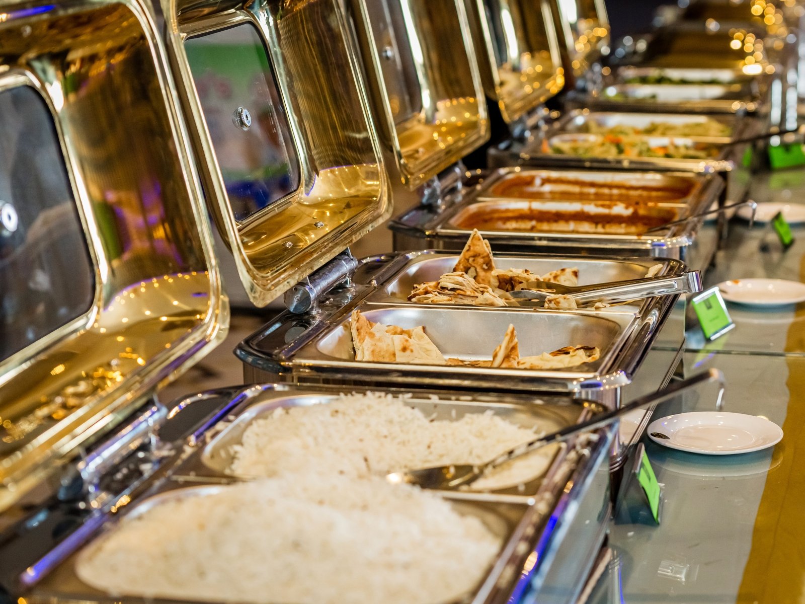 Indian buffet with rice, naan and curries served in chafing dishes